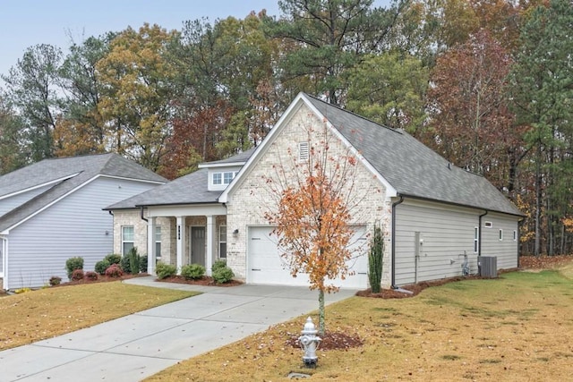 view of front facade featuring cooling unit, a front yard, and a garage