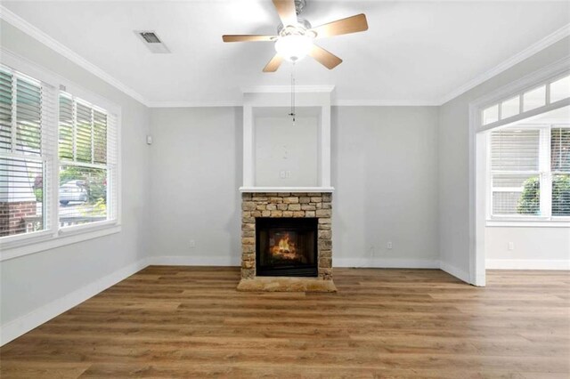 1283 Mercer, East Point, GA 30344 - unfurnished living room with a stone fireplace, ornamental molding, wood finished floors, and a ceiling fan