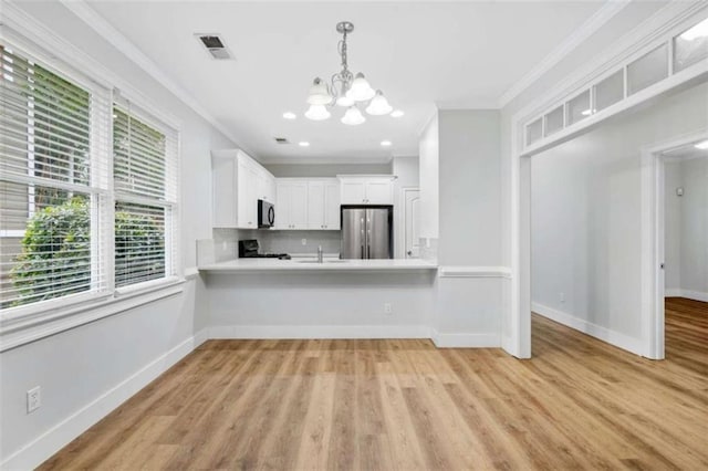 1283 Mercer, East Point, GA 30344 - kitchen featuring freestanding refrigerator, black microwave, a chandelier, light countertops, and crown molding