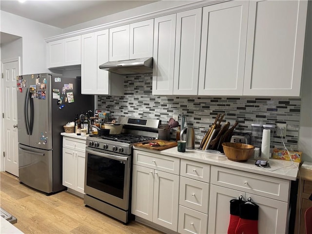 2107 Hailston Dr, Duluth, GA 30097 - kitchen with appliances with stainless steel finishes, under cabinet range hood, light wood finished floors, and light countertops