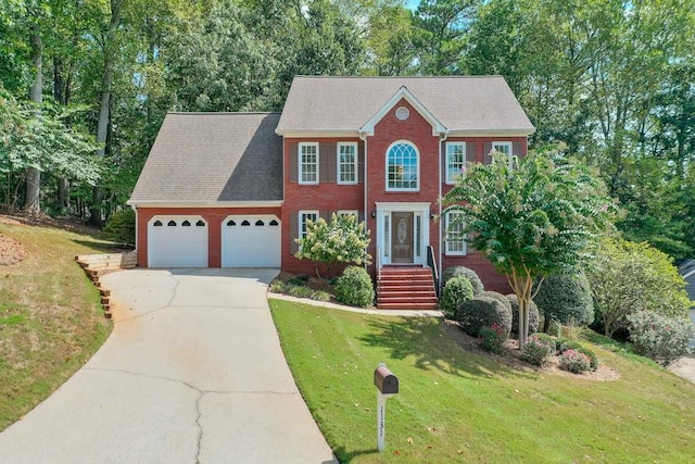 colonial house featuring a garage and a front lawn