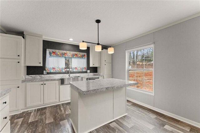 kitchen featuring white cabinets, stainless steel refrigerator, pendant lighting, and wood-type flooring