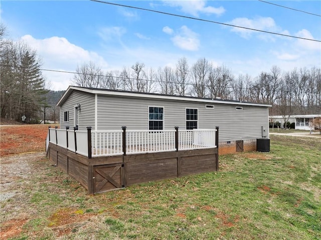 back of house featuring a yard and a deck