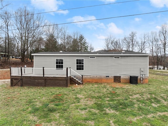 back of property with a yard, cooling unit, and a deck