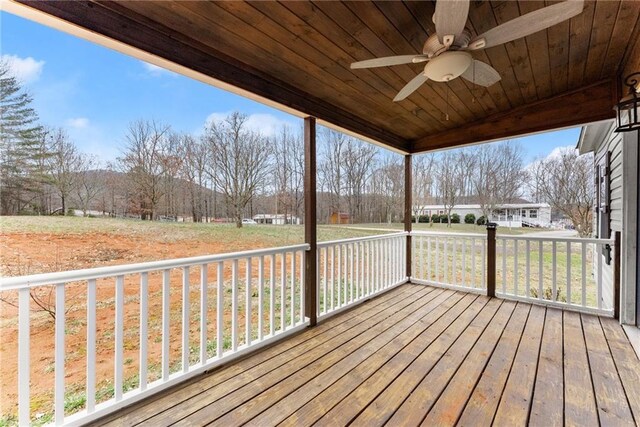 deck with ceiling fan and a yard