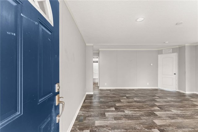 entrance foyer with crown molding and dark hardwood / wood-style floors