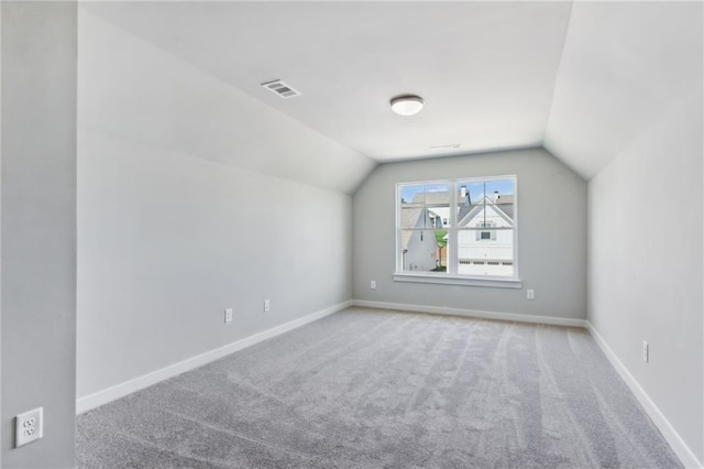 bonus room featuring carpet, visible vents, vaulted ceiling, and baseboards