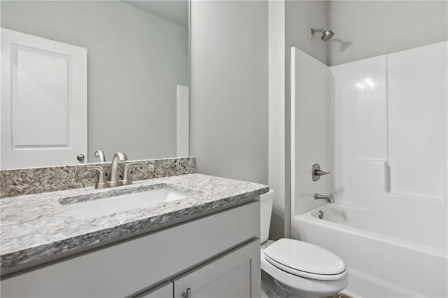 bathroom featuring toilet, bathing tub / shower combination, and vanity