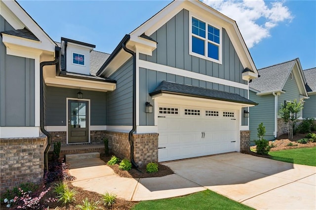 view of front facade with an attached garage, brick siding, board and batten siding, and concrete driveway