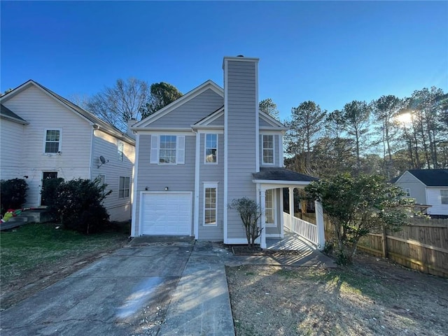 view of front of property with a chimney, a porch, concrete driveway, an attached garage, and fence