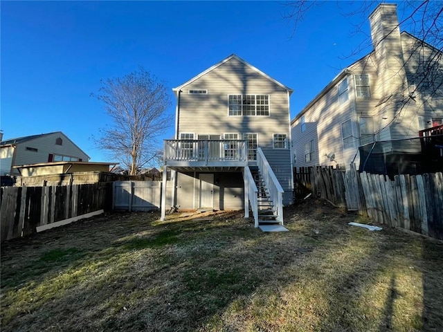 rear view of property with stairs, a deck, a lawn, and a fenced backyard