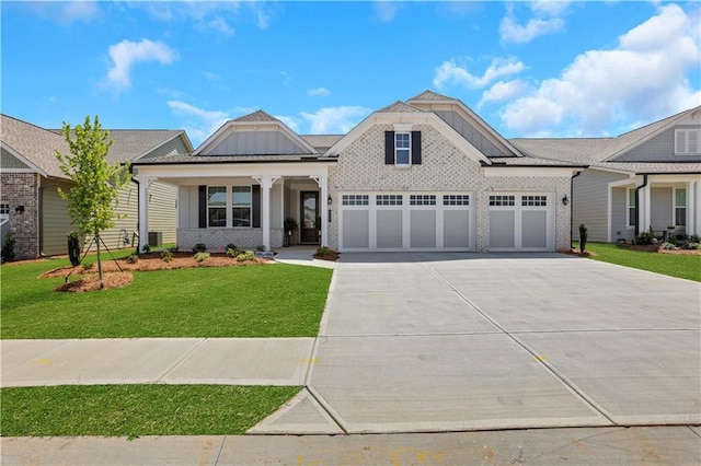 view of front facade featuring covered porch, a front yard, board and batten siding, concrete driveway, and an attached garage