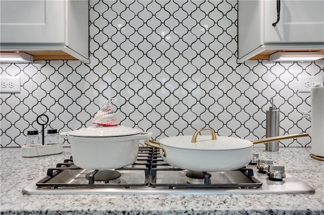 bathroom featuring decorative backsplash and toilet