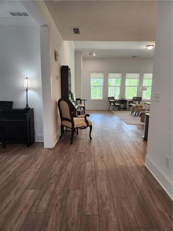 sitting room with baseboards, hardwood / wood-style floors, and visible vents