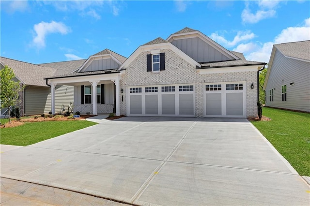 view of front facade featuring board and batten siding, a porch, driveway, a front lawn, and an attached garage