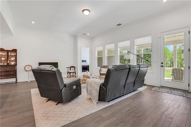 living room with baseboards, recessed lighting, wood finished floors, and visible vents
