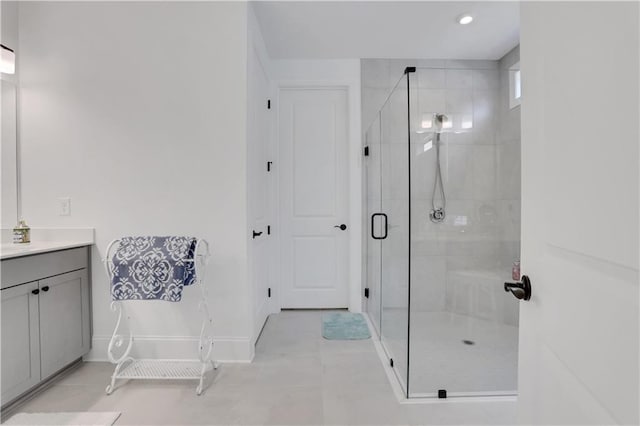 bathroom featuring a shower stall, tile patterned floors, vanity, baseboards, and recessed lighting