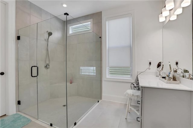 bathroom featuring vanity, baseboards, a shower stall, and recessed lighting