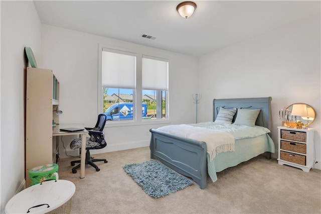 bedroom with visible vents and carpet flooring