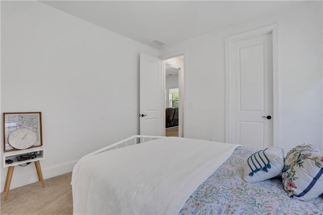 bedroom with light colored carpet, baseboards, and visible vents