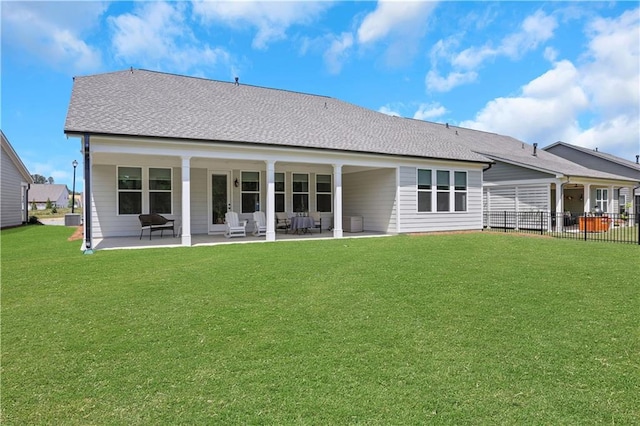 rear view of house with a lawn, central AC, fence, and a patio area