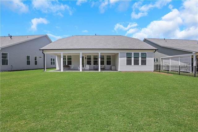rear view of house with fence, an outdoor hangout area, a lawn, and a patio area