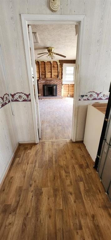 corridor with hardwood / wood-style flooring