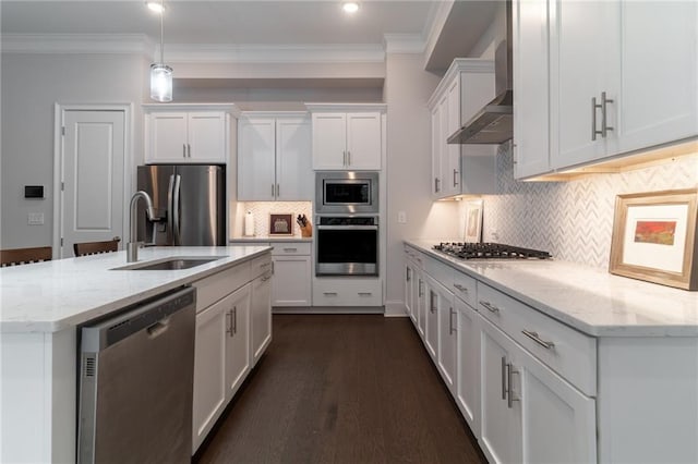 kitchen featuring wall chimney exhaust hood, white cabinetry, stainless steel appliances, sink, and backsplash