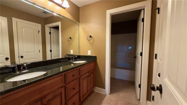 full bath featuring tile patterned flooring, visible vents, a sink, and double vanity