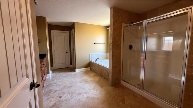 full bathroom featuring a garden tub, a shower stall, vanity, and baseboards