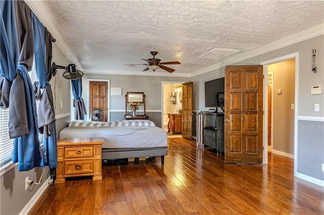 bedroom featuring ornamental molding, dark wood finished floors, a textured ceiling, and baseboards