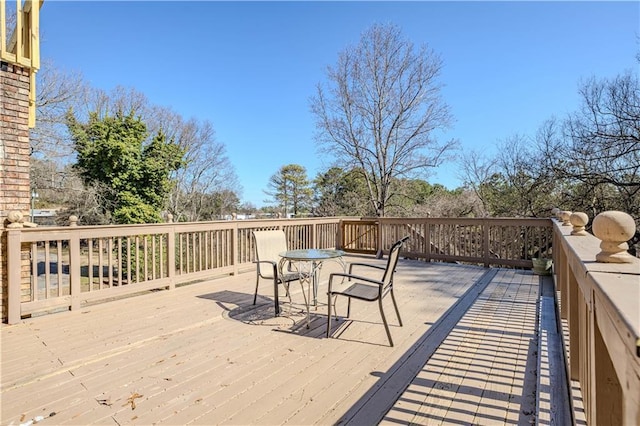 deck with outdoor dining area