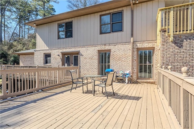 wooden terrace with outdoor dining space