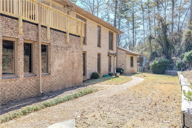 view of side of home featuring brick siding