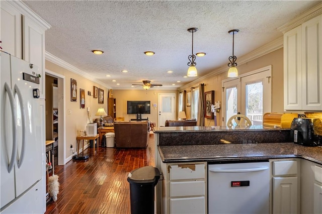 kitchen featuring white appliances, french doors, dark wood-style floors, dark countertops, and crown molding