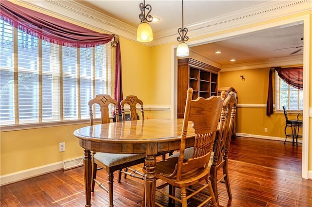 dining room featuring ornamental molding, a healthy amount of sunlight, and wood finished floors