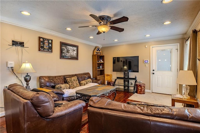 living room featuring ornamental molding, a textured ceiling, baseboards, and a ceiling fan