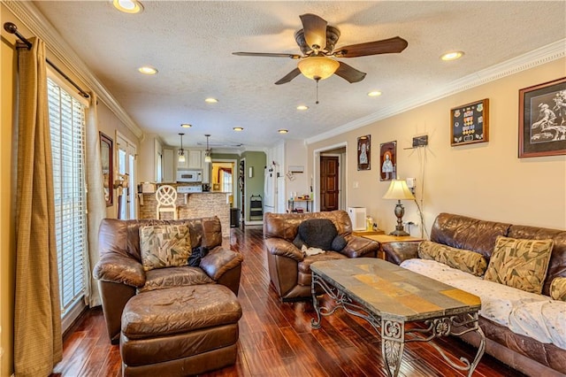 living area featuring dark wood-style floors, ornamental molding, a textured ceiling, and recessed lighting