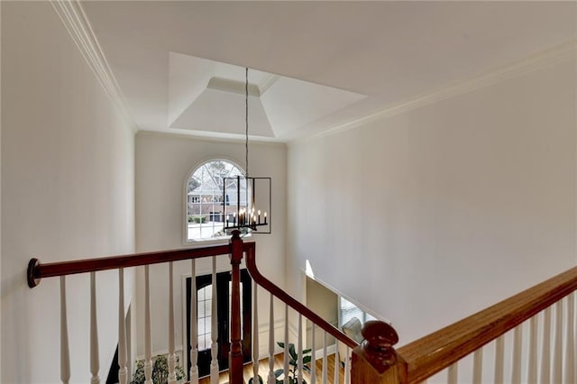 stairway with crown molding and a notable chandelier