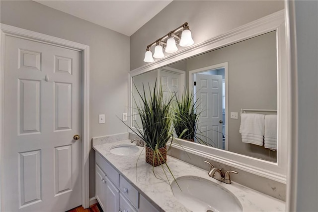 bathroom featuring double vanity and a sink