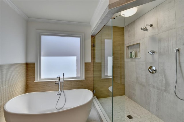 full bathroom featuring a soaking tub, tiled shower, and crown molding