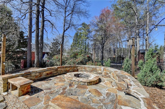 view of patio / terrace featuring fence and an outdoor fire pit