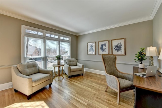 office space with light wood finished floors, baseboards, and ornamental molding