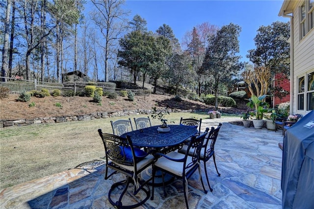 view of patio / terrace featuring outdoor dining space, a grill, and fence