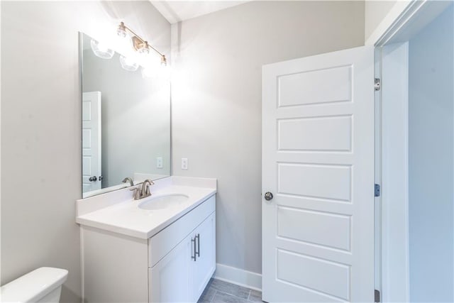 bathroom with tile patterned floors, vanity, and toilet