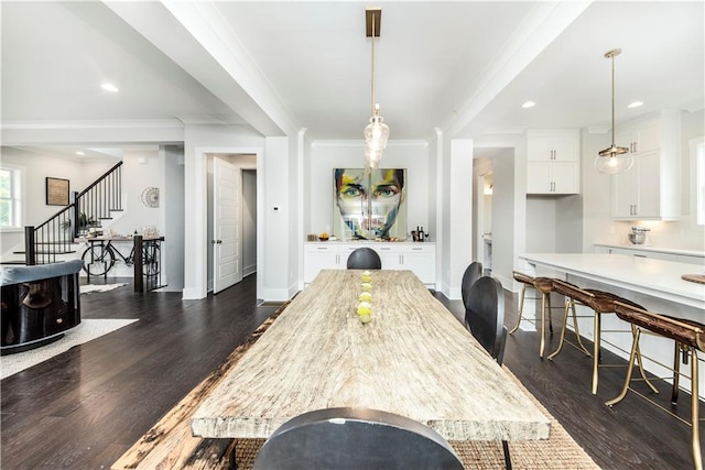 dining area featuring dark hardwood / wood-style flooring and ornamental molding