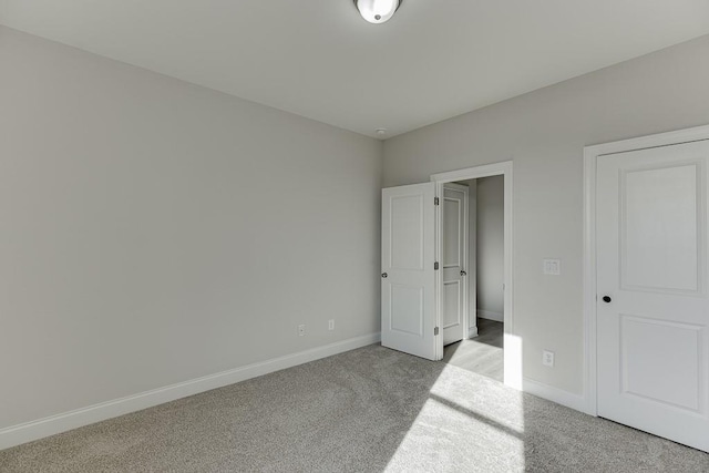 unfurnished bedroom with light colored carpet