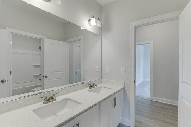 bathroom with shower / washtub combination, vanity, and hardwood / wood-style flooring