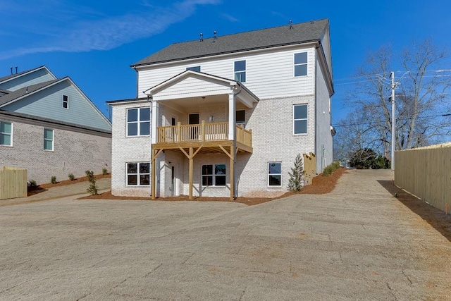 rear view of property with a balcony