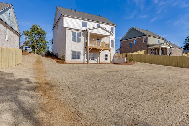 rear view of property featuring a balcony